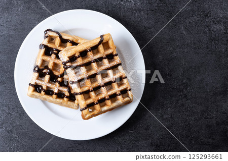 Belgian Waffles with chocolate on black slate background 125293661