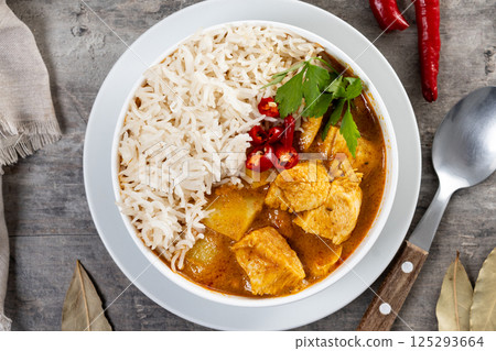 Massaman curry on wooden table. Traditional Thai food recipe Massaman curry on wooden table. Traditional Thai food recipe 125293664