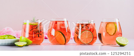 Alcoholic cocktail pink negroni with lime in glasses on table web banner Alcoholic cocktail pink negroni with lime in glasses on table web banner 125294251