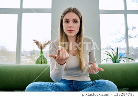 Web cam view of young serious woman talking looking in camera, online meeting, video call Web cam view of young serious woman talking looking in camera, online meeting, video call 125294783