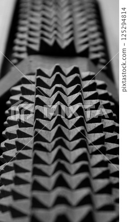 Identically spikes on jagged gray mechanism stock photo for vertical background Identically spikes on jagged gray mechanism stock photo for vertical background 125294814