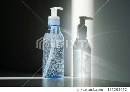 Tube of micellar gel in a ray of sunlight on a shadow background. Tube of micellar gel in a ray of sunlight on a shadow background. 125295052