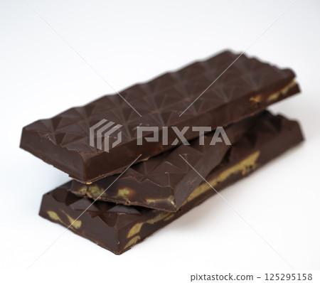 Delicious kadaif layers with rich chocolate and pistachio topping displayed on a clean, white Delicious kadaif layers with rich chocolate and pistachio topping displayed on a clean, white 125295158