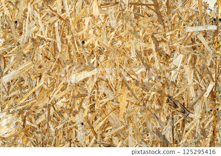 OSB board texture closeup suitable for construction, renovation and interior design projects. Wooden surface background for eco-friendly and sustainable materials OSB board texture closeup suitable for construction, renovation and interior design projects. Wooden surface background for eco-friendly and sustainable materials 125295416