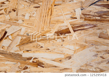 Wooden OSB panel surface with visible texture for wall, floor or ceiling design. Eco-friendly background for decor and renovation projects 125295418