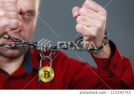 Man being tied up in block chain 125295743