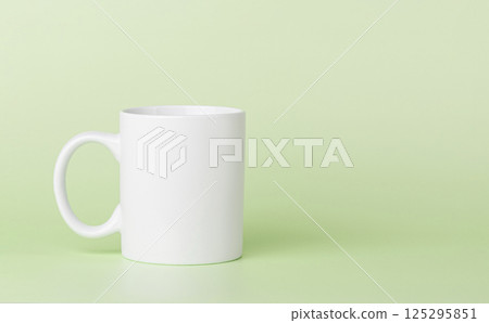 white cup for tea or coffee on a green background 125295851