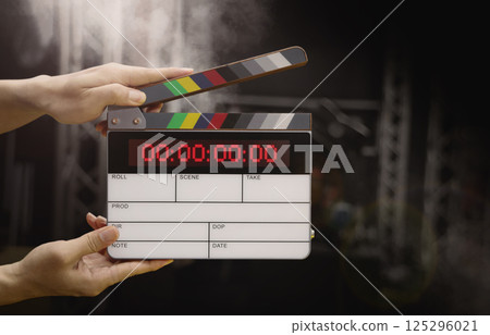 Digital film slate for filmmaker in set. Hand hitting timecode clapperboard or movie slate for Video Production. Digi number clapper board or film slates action on set. Tools in modern cinema industry Digital film slate for filmmaker in set. Hand hitting timecode clapperboard or movie slate for Video Production. Digi number clapper board or film slates action on set. Tools in modern cinema industry 125296021
