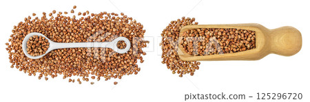 Raw buckwheat in ceramic spoon and wooden scoop isolated on white background. Top view. Flat lay 125296720
