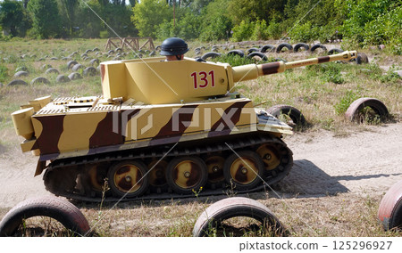 Kiev, Ukraine August 23, 2020: Children ride mock-ups of a German Tiger tank and a Russian T34 at the training ground Kiev, Ukraine August 23, 2020: Children ride mock-ups of a German Tiger tank and a Russian T34 at the training ground 125296927