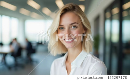 In a modern office filled with natural light, a cheerful blonde woman engages with colleagues while offering her friendly assistance and support Generative AI 125297178