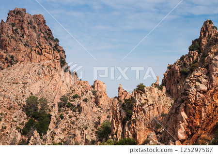 A picturesque view of rocky mountain formations under blue sky. Corsica A picturesque view of rocky mountain formations under blue sky. Corsica 125297587