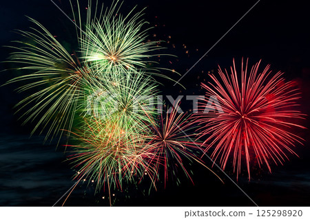 Colorful fireworks on black background. Celebration and holidays concept. Independence Day 4th of July, New Year, festival. Bright explosions of lights in sky. 125298920
