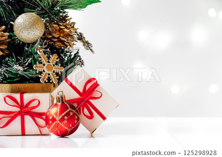 Eco-friendly artificial Christmas tree with gifts on white background. New Year concept, holiday card. 125298928