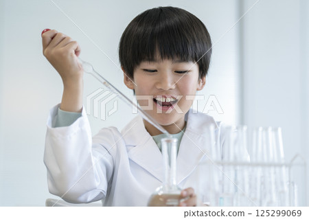 A fourth grade boy doing a science experiment 125299069