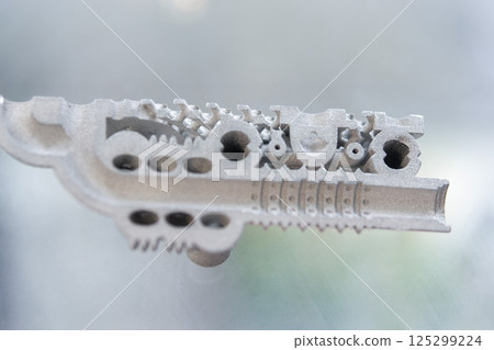 Metal object printed on 3D printer from metal powder. Model created on 3D printer from metal powder. Metal Jet technology. New modern 3D printing technologies. Additive progressive technology. Concept 125299224