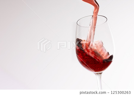 Wine poured into a glass Wine poured into a glass 125300263