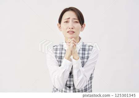 Female office worker pleading on white background 125301345