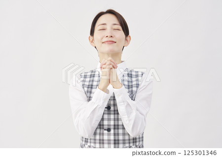 Female office worker praying white background 125301346