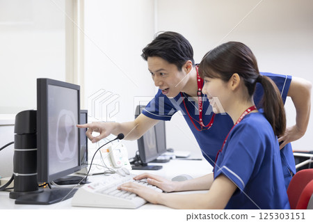 A radiologist looks at the results of a CT scan on a monitor. Photo courtesy of Denpa Gakuen, Tokyo Electronics College. 125303151