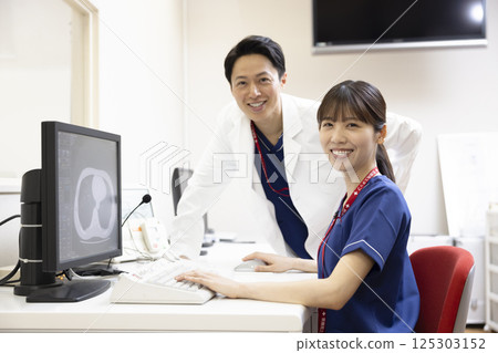 A radiologist looks at the results of a CT scan on a monitor. Photo courtesy of Denpa Gakuen, Tokyo Electronics College. 125303152