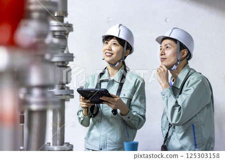 Building maintenance: A woman inspecting equipment. Photo courtesy of Denpa Gakuen, Tokyo Electronics College. Building maintenance: A woman inspecting equipment. Photo courtesy of Denpa Gakuen, Tokyo Electronics College. 125303158