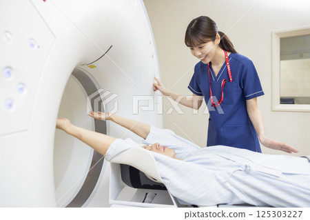 A man undergoing a CT scan with a radiologist. Photo courtesy of Denpa Gakuen, Tokyo Electronics College. A man undergoing a CT scan with a radiologist. Photo courtesy of Denpa Gakuen, Tokyo Electronics College. 125303227