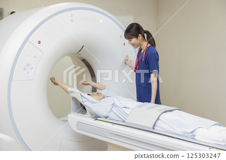 A man undergoing a CT scan with a radiologist. Photo courtesy of Denpa Gakuen, Tokyo Electronics College. A man undergoing a CT scan with a radiologist. Photo courtesy of Denpa Gakuen, Tokyo Electronics College. 125303247