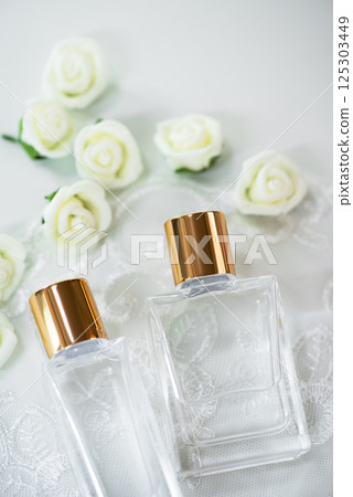 Clear glass cosmetic bottle with white lace, roses and gold cap 125303449
