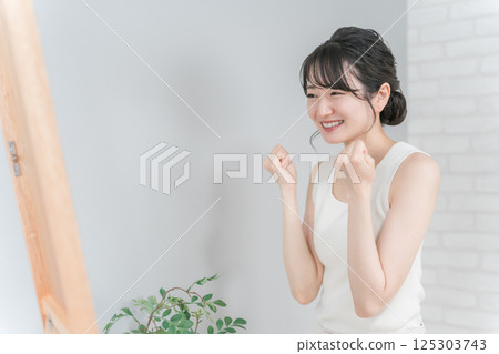 A smiling Asian woman who succeeds in dieting and loses weight and makes a guts pose A smiling Asian woman who succeeds in dieting and loses weight and makes a guts pose 125303743