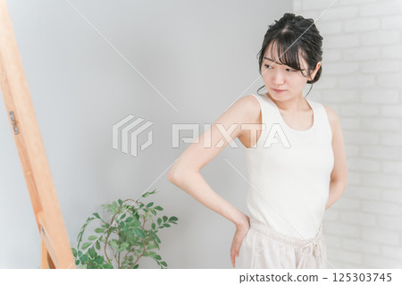 擔心在鏡子裡檢查臀部（提臀）的亞洲女性 125303745