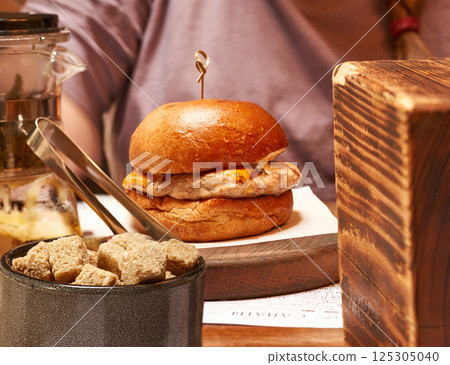 Close-up of a hamburger on the table. Side view. 125305040