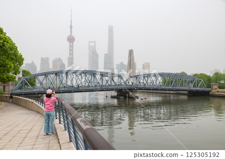 woman photograph Waibaidu bridge and Pearl tower at Bund, Shanghai 125305192