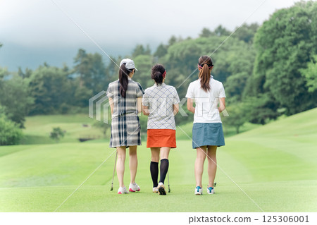 Female golfer walking along the fairway Female golfer walking along the fairway 125306001