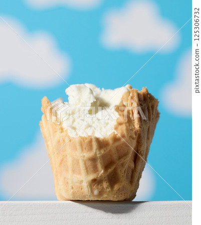 vanilla ice cream in waffle cone vanilla ice cream in waffle cone 125306732