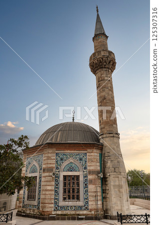 Historic Izmir Konak Mosque in Konak Meydani at sunset showcasing beautiful architecture and cultural significance Historic Izmir Konak Mosque in Konak Meydani at sunset showcasing beautiful architecture and cultural significance 125307316