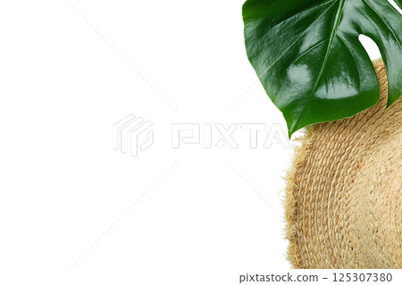Chic summer hat with a vibrant green leaf, perfect for vacation, isolated on white background 125307380