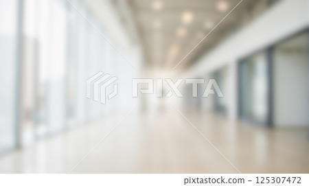 blurred empty bright indoor business corridor corporate modern spacious large windows contemporary minimalist clean architecture open commercial interior white sunlight lobby office hallway design 125307472