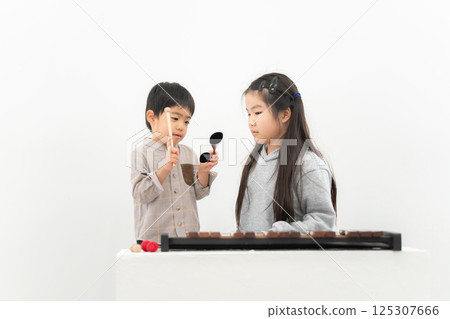 Girl practicing agogobel Girl practicing agogobel 125307666
