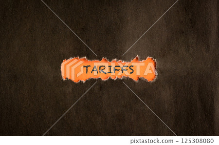 Tarrifs, word on orange paper. 125308080