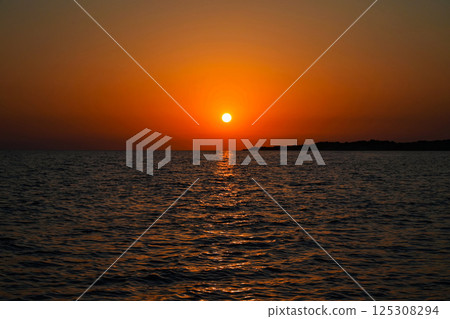 Beautiful sunset on the sea. Concept for travel, summer and vacation. Beautiful sunset on the sea. Concept for travel, summer and vacation. 125308294