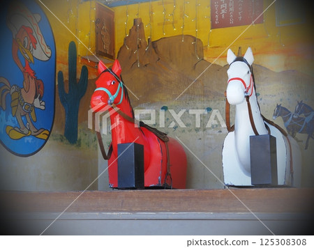 A nostalgic ride, a red and white wooden horse (20250409094835) 125308308