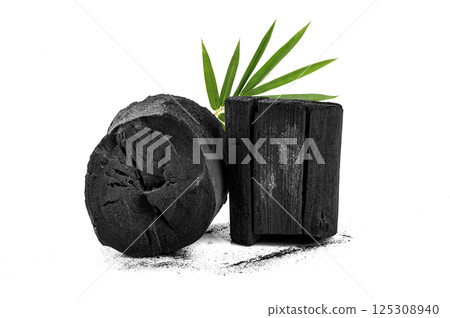 Natural charcoal with bamboo leaves on white background Natural charcoal with bamboo leaves on white background 125308940