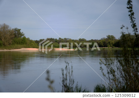 The River flows between green banks The River flows between green banks 125309012