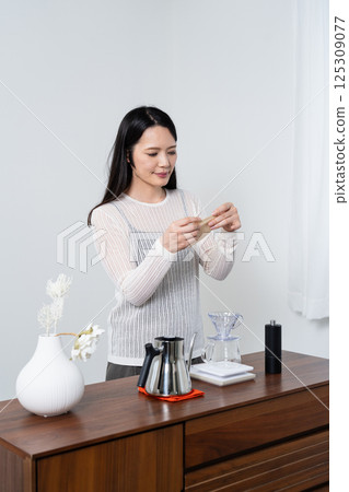 A woman preparing coffee filters A woman preparing coffee filters 125309077