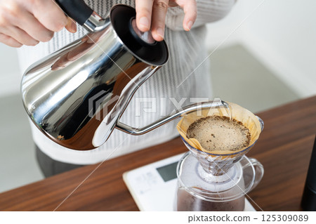 A woman brewing coffee by hand drip A woman brewing coffee by hand drip 125309089