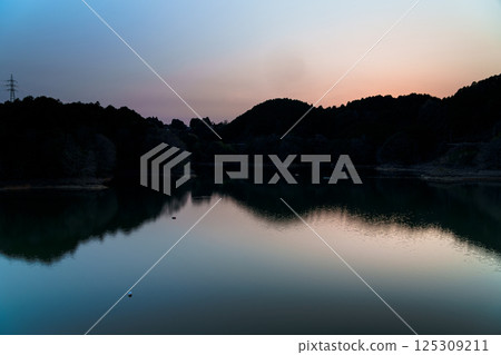 Beautiful sunset sky and reflection on the lake surface after sunset Still image 4 125309211