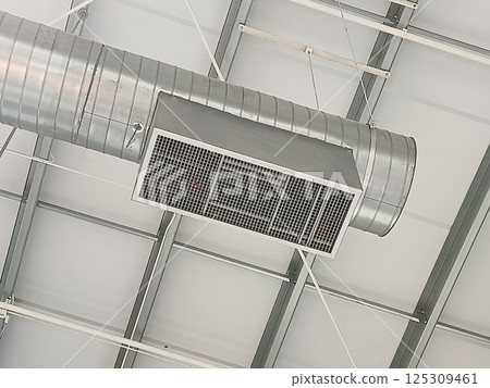 Air vent pipes for cooling air are installed on the building ceiling. 125309461
