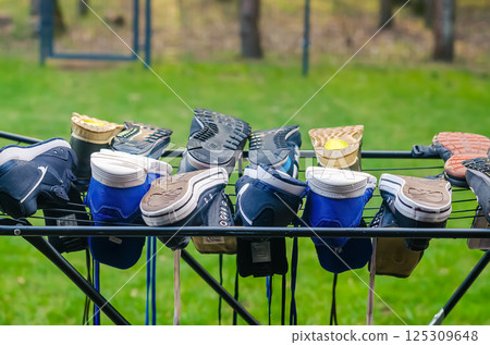 Colorful sneakers drying on metal rack outdoors in the green garden. High quality photo Colorful sneakers drying on metal rack outdoors in the green garden. High quality photo 125309648