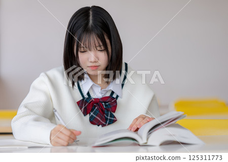 School girls studying 125311773